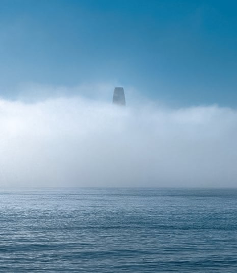 San Francisco's Salesforce Tower peeks above a thick marine layer over the bay